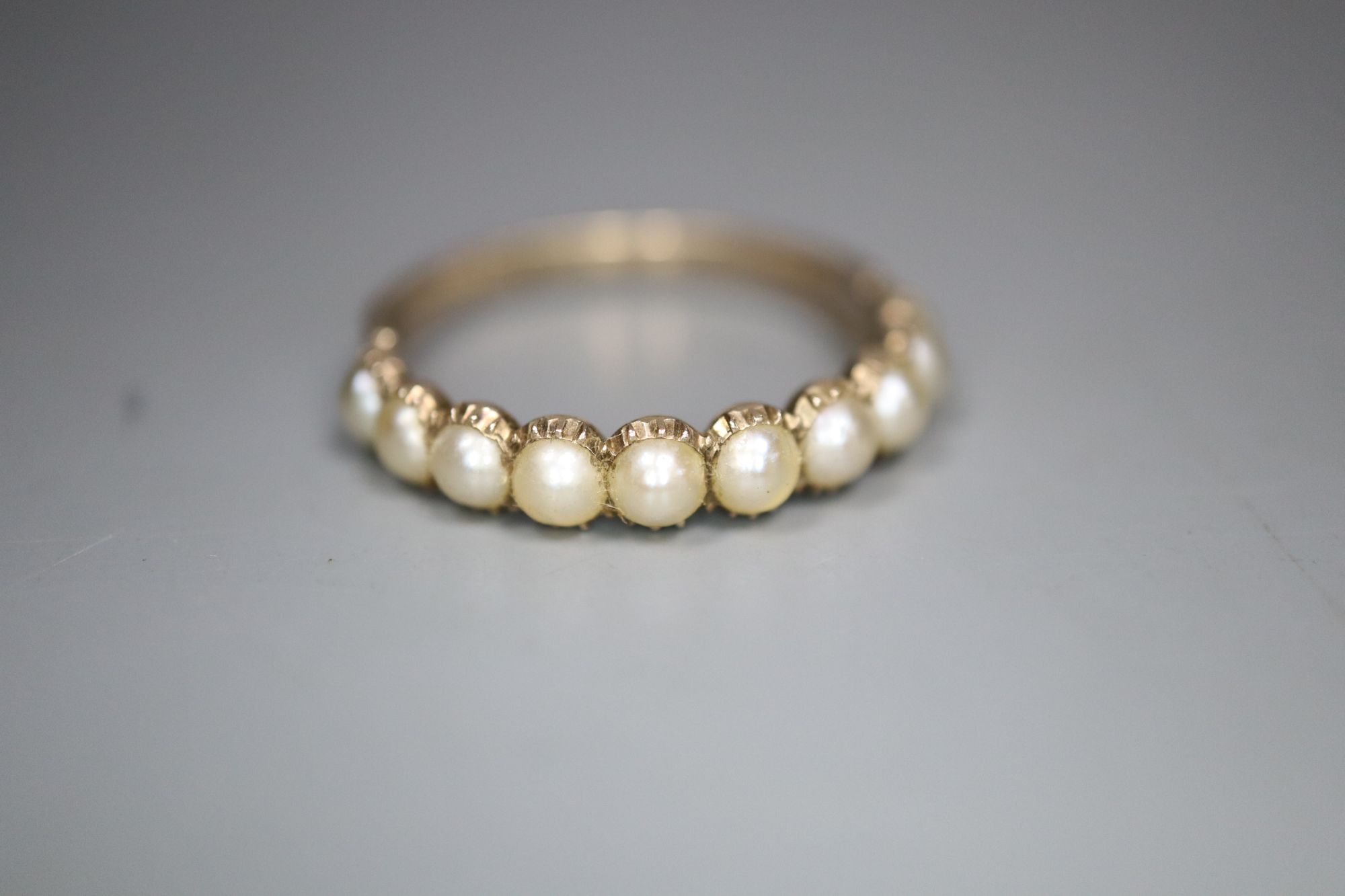 A 19th century gold and split pearl half hoop ring, set with ten pearls, gross 1.6 grams, size O/P.